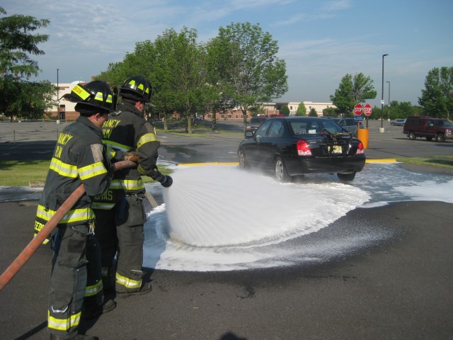 Firefighters Kevin Thomas and Josh Seeds  working a foam line on a fuel leak