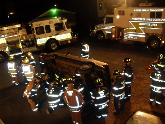 Crews from District 17 Companies work together with the Junk Yard Dawg Z Struts to stabilize a vehicle on drill night.